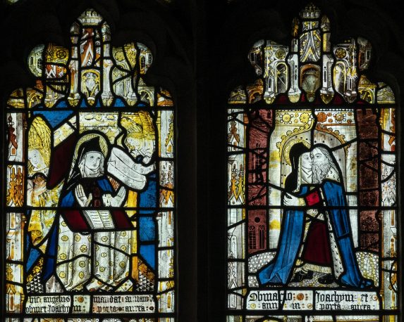 St Anne at prayer, with an angel announcing the birth of Mary; and Joachim embracing Anne at the Golden Gate (1498, restored 1872), Lady Chapel east window, Church of All Saints, Gresford. | Photo: Peter Hildebrand