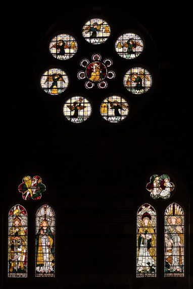 Morris, Marshall, Faulkner & Co. west window of the south aisle (1862). Left window left light St Michael by Ford Madox Brown, right light St Raphael by William Morris with face redrawn by Rossetti. Six foil above St Michael & the Dragon by Peter Paul Marshall. Right window left light St Uriel by Ford Madox Brown, right light St Gabriel by William Morris. Six foil above the Annunciation by William Morris. Rose window Virgin and Child surrounded by Angels playing bells by Edward Burne-Jones, St Michael & All Angels, Brighton | Photo: Peter Hildebrand